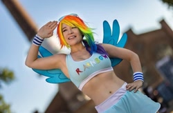 Size: 1080x709 | Tagged: safe, rainbow dash, human, g4, belly button, clothes, cosplay, costume, hand on hip, irl, irl human, photo, salute
