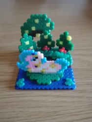 Size: 1488x1984 | Tagged: safe, artist:mariothepixelarter, princess celestia, alicorn, pony, g4, craft, female, irl, lying down, mare, perler beads, photo, prone, solo, tree