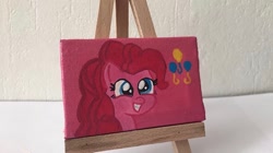 Size: 650x364 | Tagged: safe, alternate version, artist:lillycloudart, pinkie pie, earth pony, pony, canvas, eyelashes, female, grin, irl, mare, photo, smiling, solo, toy, traditional art