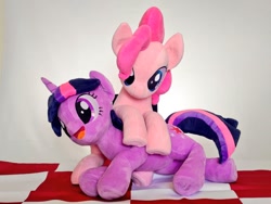 Size: 1024x768 | Tagged: safe, artist:nekokevin, pinkie pie, twilight sparkle, earth pony, pony, unicorn, g4, duo, female, frog (hoof), irl, mare, on top, open mouth, photo, picnic blanket, pinkie pie riding twilight, plushie, riding, smiling, underhoof, unicorn twilight