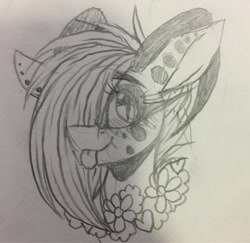 Size: 1080x1051 | Tagged: safe, artist:moshi.poni, oc, oc only, pony, :p, bust, ear piercing, eyelashes, female, floral necklace, grayscale, hair over one eye, horns, mare, monochrome, piercing, solo, tongue out, traditional art