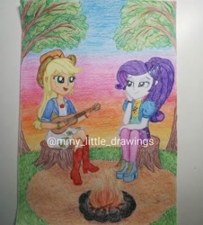 Size: 1080x1196 | Tagged: safe, artist:mmy_little_drawings, applejack, rarity, equestria girls, equestria girls specials, g4, my little pony equestria girls: better together, my little pony equestria girls: sunset's backstage pass, bedroom eyes, boots, campfire, camping, clothes, cute, eyelashes, female, guitar, high heel boots, high heels, jackabetes, lesbian, musical instrument, open mouth, outdoors, playing instrument, raribetes, ship:rarijack, shipping, shoes, shorts, sitting, smiling, sunset, traditional art, tree, tree stump, watermark