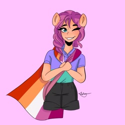Size: 2048x2048 | Tagged: safe, alternate version, artist:rapunzelights, part of a set, sunny starscout, earth pony, anthro, g5, blushing, braid, cape, clothes, eyelashes, female, grin, headcanon, high res, lesbian, lesbian pride flag, lgbt headcanon, looking at you, one eye closed, pink background, pride, pride flag, sexuality headcanon, shirt, shorts, signature, simple background, smiling, solo, teeth, wink
