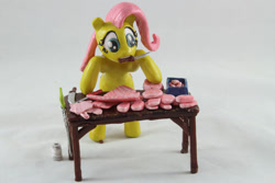 Size: 1280x854 | Tagged: safe, artist:azgchip, fluttershy, pegasus, pony, g4, bacon, bipedal, bipedal leaning, butcher, butcher knife, cooking, craft, cute, female, food, knife, leaning, meat, mouth hold, photo, ponies eating meat, pork, sculpture, solo, table, wax