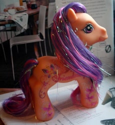 Size: 595x646 | Tagged: safe, photographer:lilcricketnoise, scootaloo (g3), g3, chair, palindrome get, paper, table, tablecloth, toy