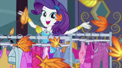 Size: 1000x563 | Tagged: safe, screencap, rarity, equestria girls, g4, my little pony equestria girls: better together, street chic, autumn leaves, bracelet, building, clothes, clothes rack, cold weather, cute, geode of shielding, jewelry, leaf, leaves, looking at you, magical geodes, makeup, open mouth, raribetes, rarity peplum dress, smiling, smiling at you, solo, talking, talking to viewer, wind, wind blowing, window