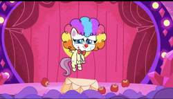 Size: 828x473 | Tagged: safe, screencap, fluttershy, pegasus, pony, g4.5, lolly-pop, my little pony: pony life, apple, bowtie, breaking the fourth wall, clown, clown makeup, clown nose, clown wig, cute, female, flutterclown, flying, food, rainbow wig, red nose, shyabetes, solo, stage