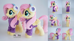 Size: 2500x1406 | Tagged: safe, artist:meplushyou, fluttershy, pegasus, pony, g4, clothes, cute, earmuffs, female, folded wings, irl, mare, photo, plushie, shyabetes, signature, smiling, solo, spread wings, sweater, wings