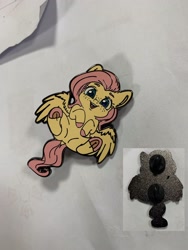Size: 1536x2048 | Tagged: safe, artist:miokomata, fluttershy, pegasus, pony, g4, colored hooves, craft, cute, enamel pin, female, freckles, freckleshy, frog (hoof), irl, mare, photo, pin, shyabetes, solo, underhoof