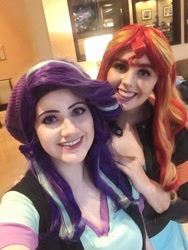 Size: 722x960 | Tagged: safe, artist:maddymoiselle, artist:sarahndipity cosplay, starlight glimmer, sunset shimmer, human, g4, beanie, clothes, cosplay, costume, duo, everfree northwest, everfree northwest 2019, hat, irl, irl human, looking at you, photo, smiling, smiling at you