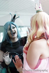 Size: 1365x2048 | Tagged: safe, artist:maddymoiselle, artist:sarahndipity cosplay, artist:silverscotty photography, princess cadance, queen chrysalis, human, g4, 2017, clothes, cosplay, costume, facebook, fangs, irl, irl human, looking at each other, open mouth, photo