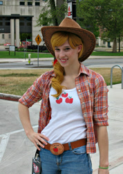 Size: 571x800 | Tagged: safe, artist:artemismooncosplay, applejack, human, trotcon, trotcon 2012, g4, clothes, cosplay, costume, cowboy hat, freckles, hand on hip, hat, irl, irl human, photo, smiling
