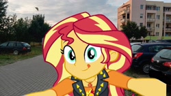 Size: 1920x1080 | Tagged: safe, sunset shimmer, equestria girls, g4, car, dusk, irl, looking at you, photo, smiling, solo, tongue out