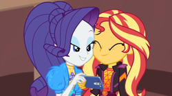 Size: 1920x1077 | Tagged: safe, screencap, rarity, sunset shimmer, equestria girls, festival filters, g4, my little pony equestria girls: better together, cellphone, duo, female, phone, smiling