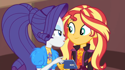 Size: 1920x1077 | Tagged: safe, screencap, rarity, sunset shimmer, equestria girls, festival filters, g4, my little pony equestria girls: better together, cellphone, clothes, duo, duo female, female, phone, smiling