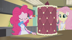 Size: 3410x1920 | Tagged: safe, screencap, fluttershy, pinkie pie, acadeca, equestria girls, g4, my little pony equestria girls: friendship games, apron, cake, clothes, duo, female, food, hairpin, smiling, tank top