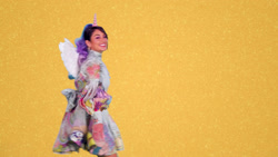 Size: 1920x1080 | Tagged: safe, screencap, human, g5, my little pony: a new generation, official, abstract background, female, foreshadowing, horn, irl, irl human, pegasus wings, photo, simple background, unicorn horn, vanessa hudgens, wings, yellow background