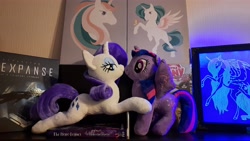 Size: 4624x2604 | Tagged: safe, applejack, princess luna, rarity, twilight sparkle, alicorn, pony, unicorn, g4, bookshelf, embrace, female, hug, irl, kissing, lesbian, looking at you, photo, photography, plushie, shelf, ship:rarilight, shipping, smug, the expanse, twilight sparkle (alicorn)