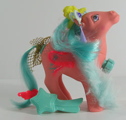Size: 634x600 | Tagged: safe, photographer:breyer600, songster, g1, barrette, bow, comb, dance 'n prance pony, ear piercing, earring, feather boa, irl, jewelry, photo, piercing, simple background, tail bow, toy