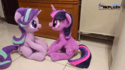 Size: 600x338 | Tagged: safe, artist:nekokevin, starlight glimmer, twilight sparkle, pony, unicorn, series:nekokevin's glimmy, g4, animated, boop, cute, duo, duo female, female, gif, glimmerbetes, happy, irl, looking at each other, mare, nekokevin is trying to murder us, open mouth, photo, plushie, raised hoof, sitting, smiling, starlight glimmer plushie, stop motion, twiabetes, underhoof, unicorn twilight, watermark