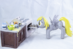 Size: 5036x3358 | Tagged: safe, artist:azgchip, derpy hooves, pegasus, pony, g4, baking, baking powder, batter, cabinet, countertop, craft, crouching, cutie mark, egg carton, female, flour, food, ingredients, mare, milk bottle, mouth hold, muffin, muffin tray, oven, photo, salt, sculpture, solo, spread wings, stove, wax, wings