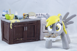 Size: 3860x2574 | Tagged: safe, artist:azgchip, derpy hooves, pegasus, pony, g4, baking, batter, cabinet, counter top, craft, cute, egg carton, female, flour, food, high res, looking at you, mare, milk bottle, mouth hold, muffin, muffin tray, oven, photo, salt, sculpture, solo, spread wings, stove, wall eyed, wax, wings, wooden spoon