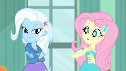 Size: 3410x1920 | Tagged: safe, screencap, fluttershy, trixie, a little birdie told me, equestria girls, g4, my little pony equestria girls: better together, clothes, crossed arms, cutie mark, cutie mark on clothes, female, geode of fauna, hairpin, hoodie, jewelry, magical geodes, necklace, open mouth