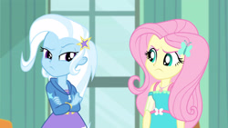 Size: 3410x1920 | Tagged: safe, screencap, fluttershy, trixie, a little birdie told me, equestria girls, g4, my little pony equestria girls: better together, clothes, crossed arms, cutie mark, cutie mark on clothes, female, geode of fauna, hairpin, hoodie, jewelry, magical geodes, necklace