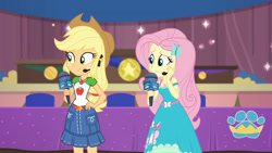 Size: 3410x1920 | Tagged: safe, screencap, applejack, fluttershy, best in show: the victory lap, equestria girls, g4, my little pony equestria girls: better together, applejack's hat, applejack's skirt, belt, best in show logo, clothes, cowboy hat, cutie mark, cutie mark on clothes, denim skirt, female, geode of fauna, geode of super strength, hairpin, hand on hip, hat, jewelry, magical geodes, microphone, necklace, skirt, smiling