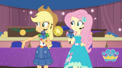 Size: 3410x1920 | Tagged: safe, screencap, applejack, fluttershy, best in show: the victory lap, equestria girls, g4, my little pony equestria girls: better together, applejack's hat, applejack's skirt, best in show logo, clothes, cowboy hat, cutie mark, cutie mark on clothes, female, fluttershy boho dress, hairpin, hand on hip, hat, jewelry, microphone, necklace, smiling