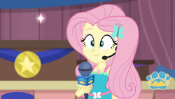 Size: 3410x1920 | Tagged: safe, screencap, fluttershy, best in show: the victory lap, equestria girls, equestria girls series, g4, spoiler:eqg series (season 2), best in show logo, female, geode of fauna, hairpin, jewelry, magical geodes, microphone, necklace, smiling, solo