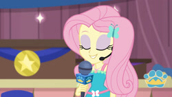 Size: 3410x1920 | Tagged: safe, screencap, fluttershy, best in show: the victory lap, equestria girls, g4, my little pony equestria girls: better together, best in show logo, eyes closed, female, geode of fauna, hairpin, jewelry, magical geodes, microphone, necklace, smiling, solo