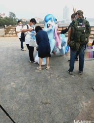 Size: 720x944 | Tagged: safe, oc, oc:lyre wave, human, inflatable pony, china, inflatable, inflatable toy, inflation valve, irl, irl human, opaque inflatable, open inflation valve, outdoors, photo, qingdao, qingdao brony festival, standing