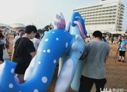 Size: 720x524 | Tagged: safe, oc, oc:lyre wave, human, inflatable pony, building, china, female, inflatable, inflatable toy, irl, irl human, male, man, mare, opaque inflatable, outdoors, photo, qingdao brony festival, standing