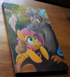Size: 659x716 | Tagged: safe, artist:kenket, artist:spainfischer, discord, fluttershy, draconequus, pegasus, pony, g4, acrylic painting, female, handmade, hug, hugging a pony, irl, looking at each other, male, mare, painting, scenery, selling, smiling, smiling at each other, snuggling, traditional art, wood