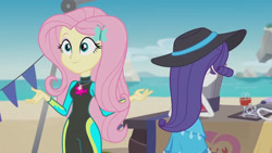 Size: 3410x1920 | Tagged: safe, screencap, fluttershy, rarity, equestria girls, equestria girls series, g4, too hot to handle, beach, clothes, female, fluttershy's wetsuit, geode of fauna, hairpin, hat, high res, jewelry, legs together, magical geodes, necklace, rarity's blue sarong, sarong, smiling, sun hat, swimsuit, wetsuit
