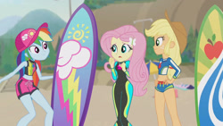 Size: 3410x1920 | Tagged: safe, screencap, applejack, fluttershy, rainbow dash, blue crushed, equestria girls, equestria girls series, g4, applejack's beach shorts swimsuit, applejack's hat, beach, belly button, cap, clothes, cowboy hat, female, fluttershy's wetsuit, geode of fauna, geode of super speed, geode of super strength, hairpin, hand on hip, hat, high res, jewelry, magical geodes, necklace, open mouth, sleeveless, smiling, surfboard, swimming trunks, swimsuit, wetsuit