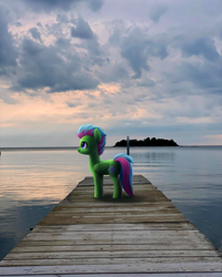 Size: 800x1000 | Tagged: safe, artist:luminousdazzle, luminous dazzle, pegasus, pony, digital art, female, irl, lake, photo, photography, pier, ponies in real life, smiling, solo, sunset, sweden, water