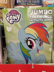Size: 3120x4160 | Tagged: safe, rainbow dash, pegasus, pony, coloring book, dollar tree, female, irl, irl photo, my little pony jumbo coloring book, my little pony logo, open mouth, photo, raised hoof, solo, solo female, spread wings, wings