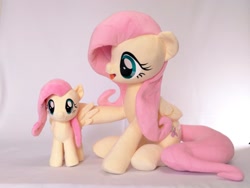 Size: 1024x768 | Tagged: safe, artist:nekokevin, fluttershy, pegasus, pony, g4, cute, daaaaaaaaaaaw, doll, duality, duo, duo female, female, irl, looking at each other, looking at someone, open mouth, photo, plushie, self paradox, self plushidox, self ponidox, shyabetes, simple background, size difference, smiling, toy, wings