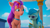 Size: 1366x768 | Tagged: safe, screencap, rosedust (g5), sunny starscout, earth pony, pony, ali-conned, g5, my little pony: make your mark, my little pony: make your mark chapter 2, spoiler:g5, bag, blue mane, cellphone, day, duo, duo female, female, fluttershy's cutie mark, green skin, magenta mane, mare, multicolored mane, orange skin, phone, purple mane, saddle bag, sky, smartphone, standing, sunglasses, sunglasses on head, twilight sparkle's cutie mark