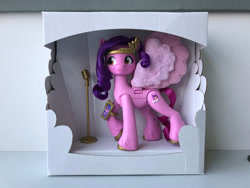 Size: 2500x1875 | Tagged: safe, pipp petals, pegasus, pony, g5, my little pony: a new generation, behind the scenes, cardboard box, cellphone, concave belly, female, irl, mare, microphone, packaging, phone, photo, prototype, raised hoof, red eyes, red-eyed pipp, singing star princess petals, skinny pipp, slender, smartphone, solo, thin, toy