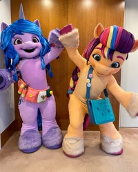 Size: 1080x1350 | Tagged: safe, izzy moonbow, sunny starscout, earth pony, human, pony, unicorn, g5, official, bag, clothes, costume, fursuit, irl, irl human, mane stripe sunny, mascot, mascot costume, photo, ponysuit