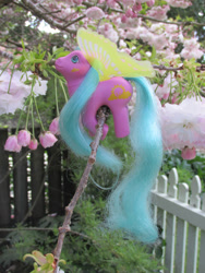 Size: 774x1032 | Tagged: safe, photographer:normaleeinsane, sun glider, g1, fence, irl, photo, toy, tree, windy wing ponies