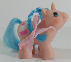 Size: 688x600 | Tagged: safe, photographer:breyer600, li'l cupcake, pony, unicorn, g1, baby, baby pony, bow, braid, brushable, irl, photo, ribbon, smiling, toy