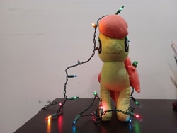 Size: 4000x3000 | Tagged: safe, artist:topsangtheman, peachy sweet, earth pony, pony, g4, apple family member, christmas, christmas lights, holiday, irl, looking at you, photo, plushie, solo