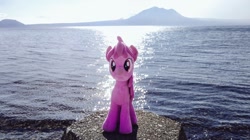Size: 1024x572 | Tagged: safe, photographer:pakapaka1993, berry punch, berryshine, earth pony, pony, g4, irl, japan, mountain, ocean, photo, plushie, rock, solo, water