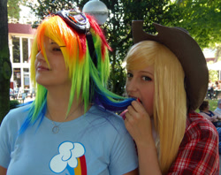 Size: 1080x857 | Tagged: safe, artist:tifachronicles, artist:yo-cosplay, applejack, rainbow dash, human, g4, 2012, clothes, cosplay, costume, cowboy hat, goggles, hat, irl, irl human, multicolored hair, photo, rainbow hair