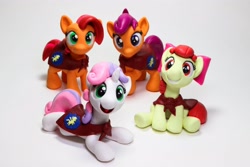 Size: 4096x2731 | Tagged: safe, artist:dustysculptures, apple bloom, babs seed, scootaloo, sweetie belle, earth pony, pegasus, pony, unicorn, bow, cape, clothes, cmc cape, craft, cutie mark crusaders, female, filly, foal, hair bow, photo, sculpture, smiling, traditional art