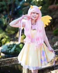 Size: 1280x1600 | Tagged: safe, alternate version, artist:tinemarieriis, fluttershy, human, g4, armpits, clothes, cosplay, costume, cutie mark on clothes, irl, irl human, one eye closed, photo, solo, wink